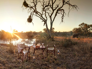 Sundowners at the Waterhole at Kings Camp - Timbavati Game Reserve - Timbavati Reservations Sundowners Waterhole Kings Camp Timbavati Game Reserve Accommodation Booking Hoedspruit Mpumalanga Five Star